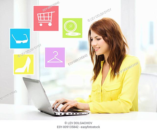 fashion, sale, people and technology concept - smiling woman with laptop computer shopping online ant home