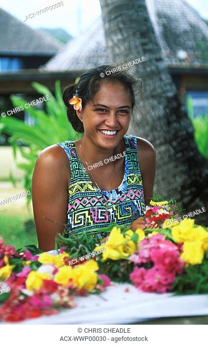 Cook Islands, South Pacific, Raratonga, local woman makes floral leis