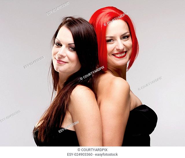 Two Young Female Friends Comparing Wig and Real Hair