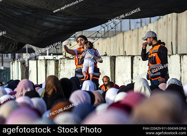 29 April 2022, Palestinian Territories, Ramallah: Palestinian women wait to cross the Qalandia checkpoint to attend the last Friday prayer of the holy fasting...