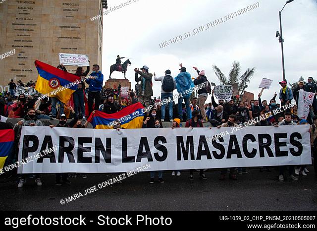 A group of demonstrators hold a sign that reads ""Stop the massacres"" on may 5, 2021 in Bogota, Colombia. After police brutality cases escalated to at least 19...