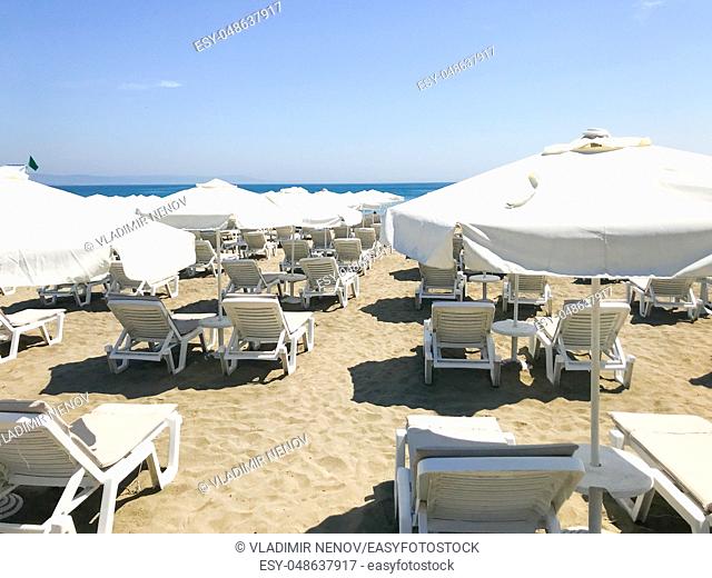 White Loungers And Umbrellas At The Beach In Pomorie, Bulgaria
