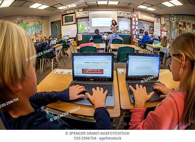 Third grade students enter information in their Google Chromebook laptop computers in a San Clemente, CA, elementary school classroom