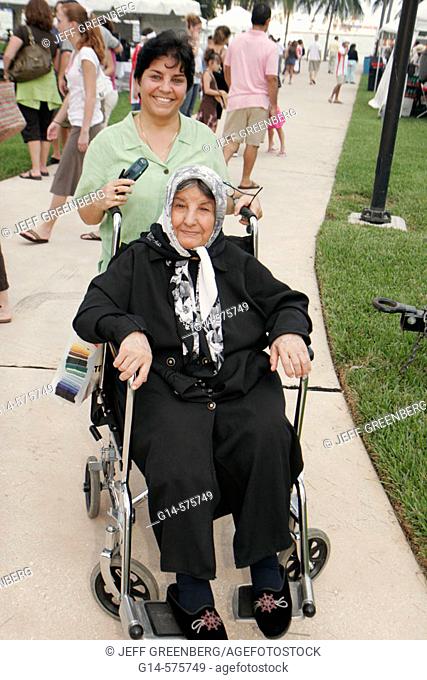 Iran, Persian, disabled mother, wheelchair, daughter, family. Iranian Festival. Bayfront Park. Miami. Florida. USA