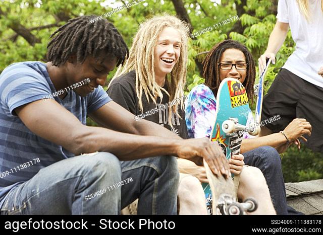 Friends with skateboards hanging out