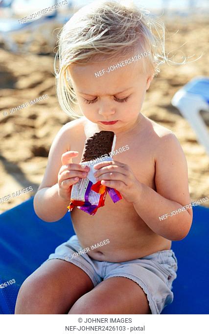 Girl having snack on beach