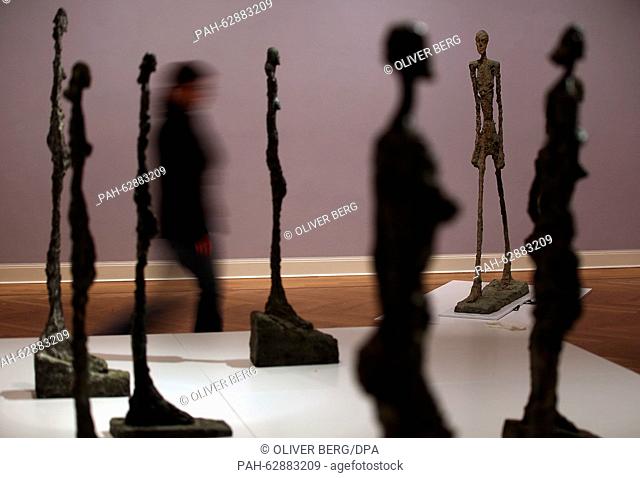 A woman walks through the exhibition of ten sculpture by Alberto Giacometti in the Picasso museum in Muenster, Germany, 23 October 2015