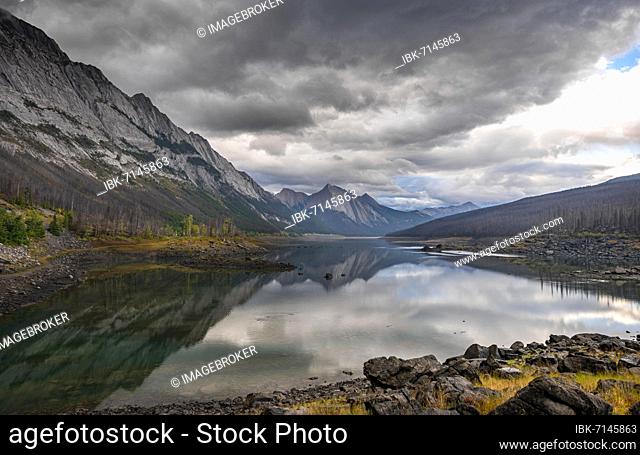 Mountains reflected in a lake, Medicine Lake, Maligne Valley, Jasper National Park, Alberta, Canada, North America