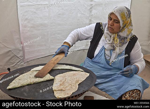 Women baking traditional lahmacun pizza bread in Anatolia, Turkey