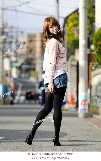 Japanese Girl poses on the street in Jiyugaoka, Japan. Jiyugaoka is a town located in Tokyo