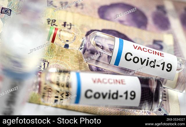 Coronavirus vial on Chinese banknotes, conceptual image