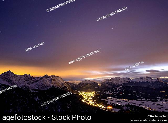 Night shot and long exposure in the mountains of Mittenwald, the Karwendel and Wetterstein mountains with snow after sunset