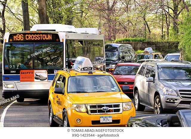 Taxi and Public MTA M96 bus crossing Central Park, New York City, 2011