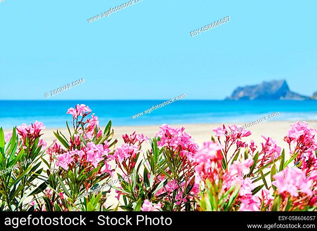 Beach of Moraira during sunny summer day, spanish coastal town. Spain