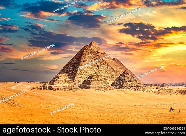 Great egyptian pyramids at cloudy sunset in Giza