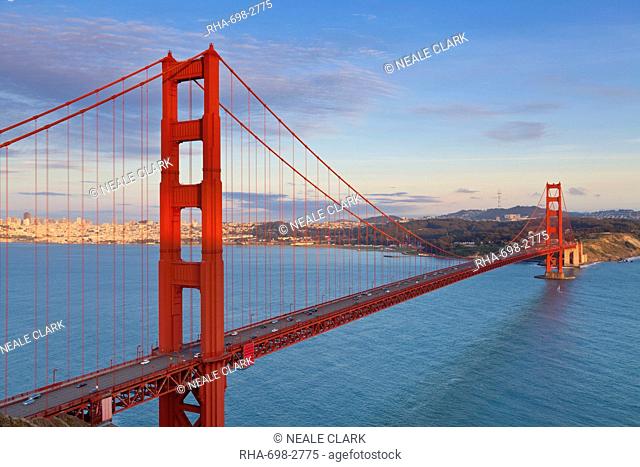 The Golden Gate Bridge, linking the city of San Francisco with Marin County, taken from the Marin Headlands at sunset with the city in the background