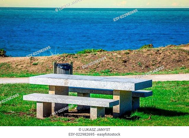 Secluded place for meditations on the sea shore. On a bench