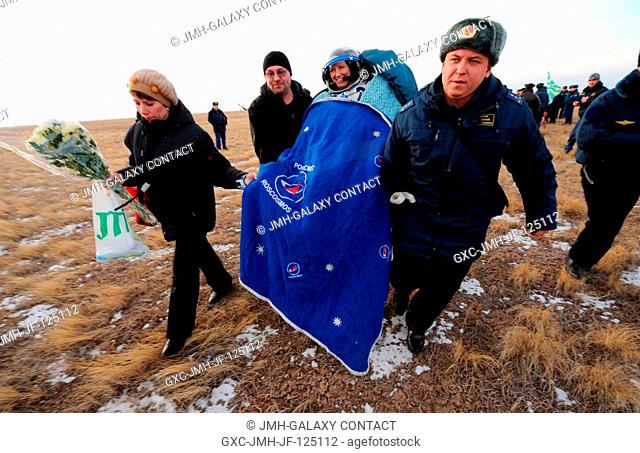 NASA astronaut Shannon Walker, Expedition 25 flight engineer, is carried to a nearby medical tent following the landing of the Soyuz TMA-19 spacecraft near the...