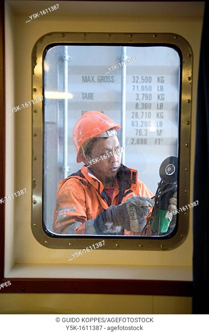 An Indonesian seaman or sailor on the container-vessel MV Flintercape, during a journey from Rotterdam, Netherlands, to Sundsvall, Sweden