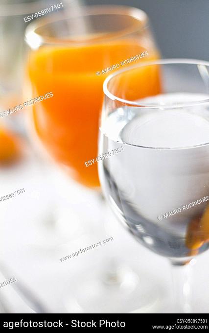 Close up view of glasses full of freshly made orange juice and water