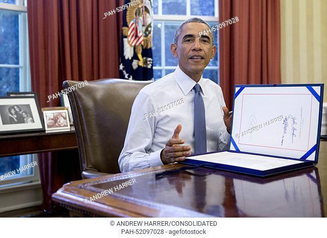 United States President Barack Obama speaks to photographers after signing House Joint Resolution 124, the Continuing Appropriations Resolution, 2015