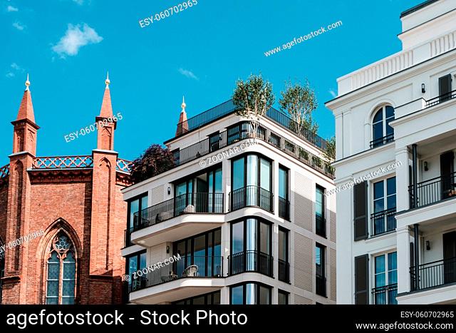 modern apartment buildings and old church facade - real estate Berlin, Mitte -