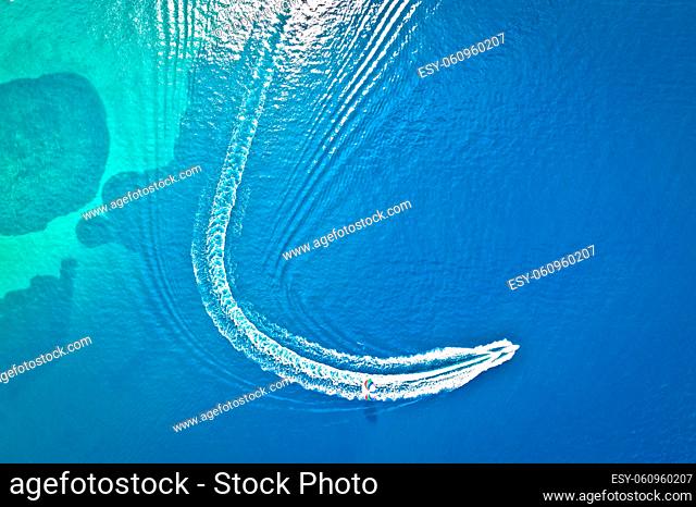 Speed boat and water parachute or parasailing aerial view, beach sports and fun