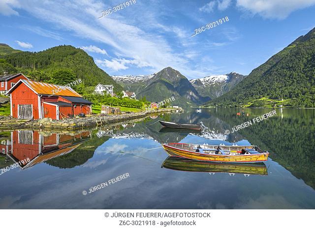 boats and red fishermen hut, Norway, seahore and bay of Balestrand with mirroing of glacier mountains, Esefjorden, Sognefjorden