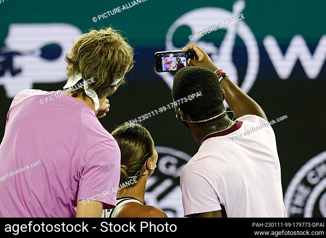 11 January 2023, Australia, Melbourne: Alexander Zverev (l) of Germany takes a selfie during the tennis charity event ""Tennis plays for peace"" before the...