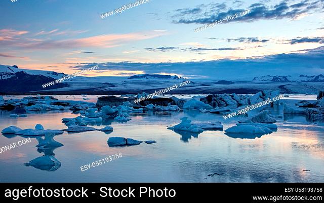 Jokulsarlon, glacier lagoon in Iceland at night with ice floating in water. Cold arctic nature landscape scenery. Ice melting
