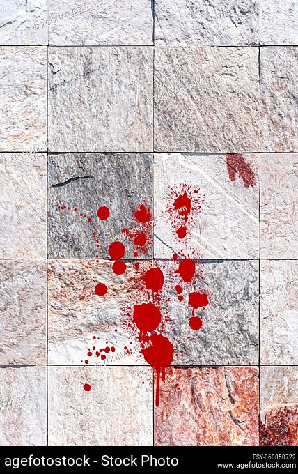 Red blood splatter on stone wall. Horror and crime background concept
