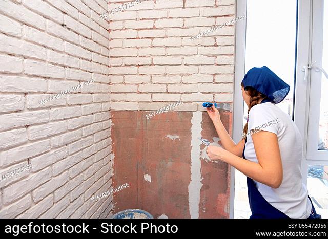 woman, renovation, plastering, brick wall