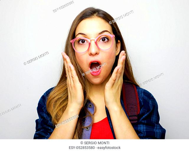 Astonished student receiving surprising news. Studio portrait on white background