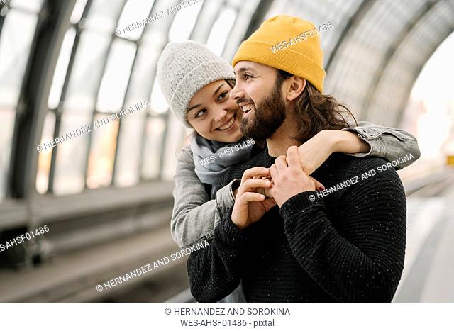 Happy young couple at the station platform, Berlin, Germany