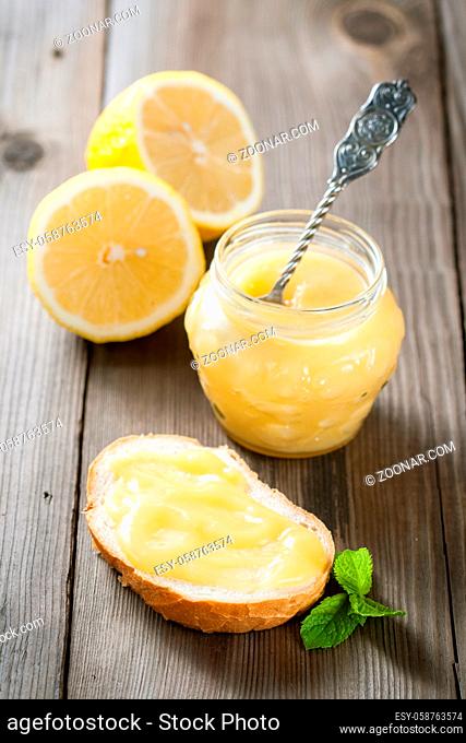 Homemade lemon curd on the toast and in a jar