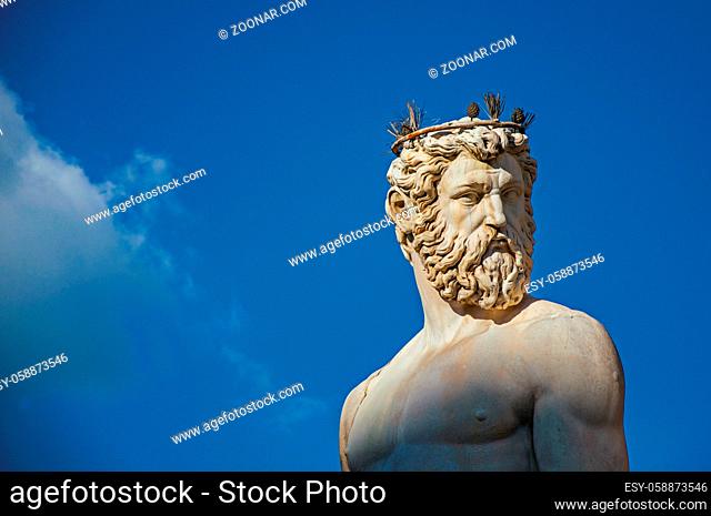Close-up of marble head of statue in Fontana del Nettuno (Neptune fountain) at sunset. In the city of Florence, the famous and amazing capital of the Italian...