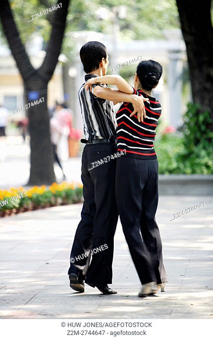 Couple during a public dance lesson on Shamian Dao Sand Surface Island, Guangzhou, China