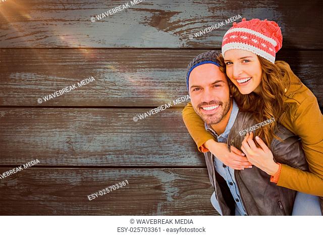 Composite image of man giving piggyback ride to woman