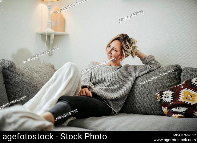 Woman sitting relaxed on the couch