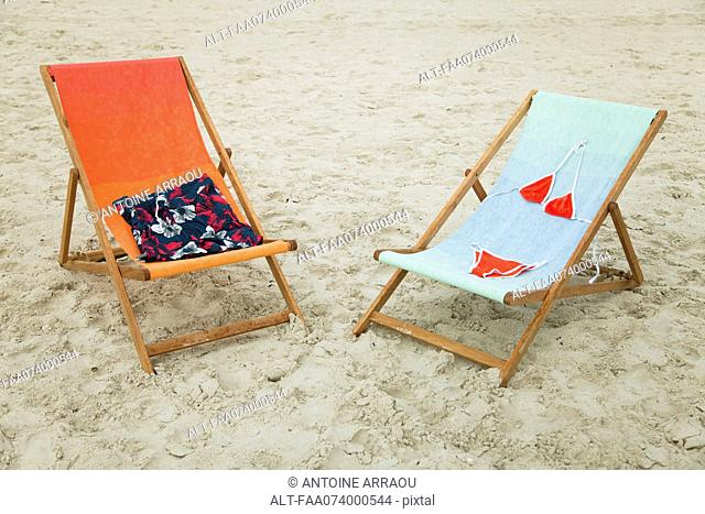 Swimsuits left on lounge chairs at the beach