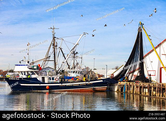 Commercial fishing vessel having a fish net removed from the net spool at Steveston Harbour, British Columbia, Canada