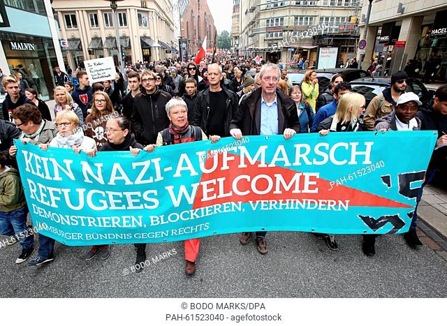 Demonstrators from the Hamburger Buendnis gegen Rechts (Hamburg anti-rightwing association) carry a banner that reads ""Kein Nazi-Aufmarsch - Refugees Welcome""...