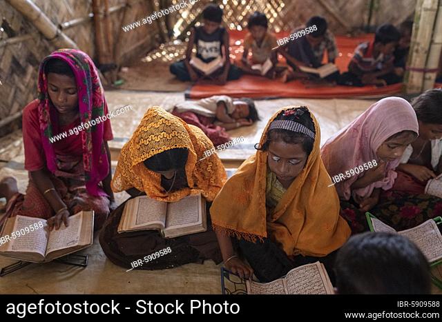 Girls reading in a madrasah, Koran school, camp for Rohingya refugees from Myanmar, Kutupalong, Cox Bazar, Bangladesh, Asia