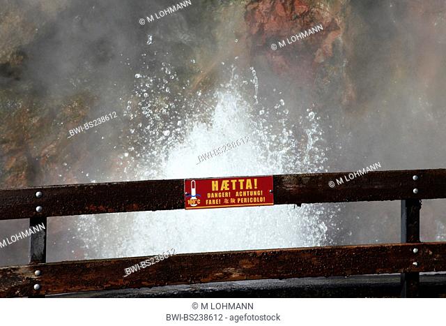sign warning of splashing hot water and steam at a fence in a geothermically active region at Deildartunguhver, Iceland, Suedwest Island