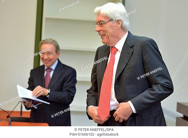 Former BayernLB manager Werner Schmidt (R) and former member of the supervisory board of BayernLB Rudolf Harnisch (L) stand in a courtroom as the trial against...