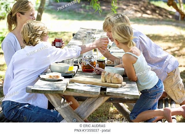Family having food at front or back yard