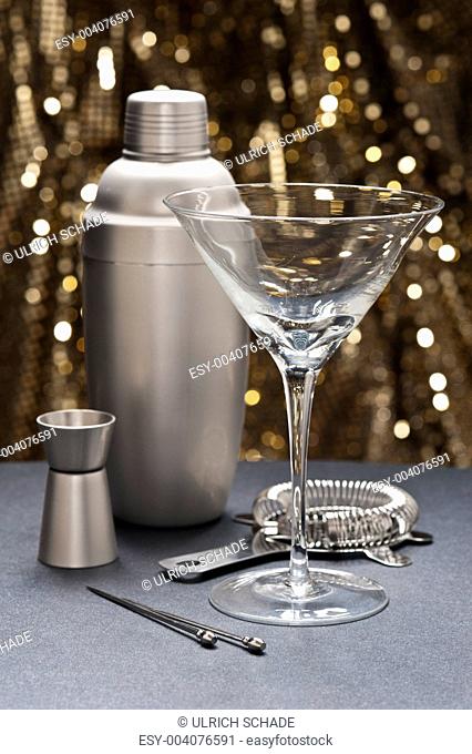 One Martini glass with bartender tools