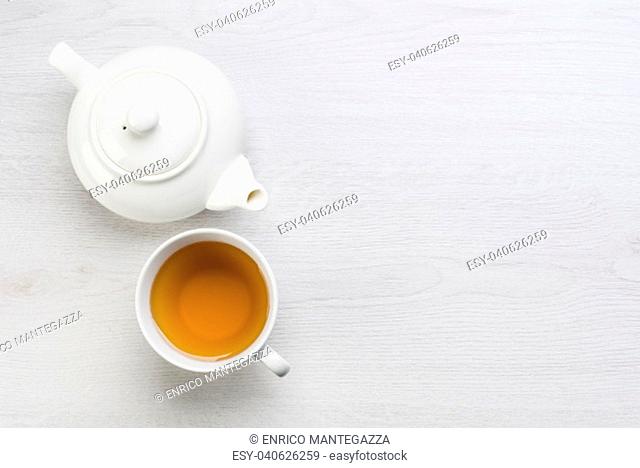 teapot and cup of tea on white table