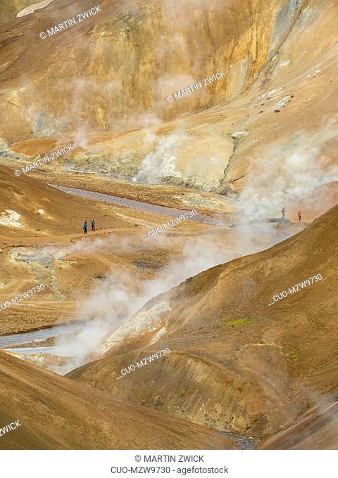 Hikers in the geothermal area Hveradalir in the mountains Kerlingarfjoell in the highlands of Iceland. Europe, Northern Europe, Iceland, August