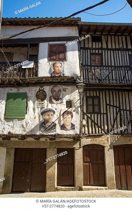 Facades of traditional houses with portraits painted on them. Mogarraz, Sierra de Francia Nature Reserve, Salamanca province, Castilla Leon, Spain